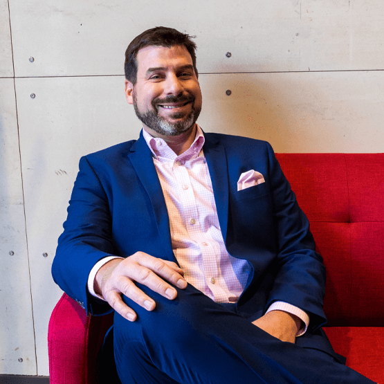 Eric Jaske - man posing for photo in suit