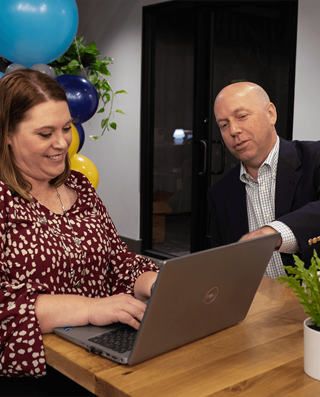 woman on laptop sitting next to man