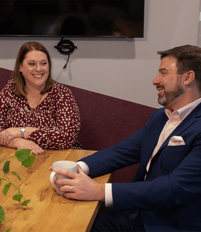 man and woman sitting at conference table