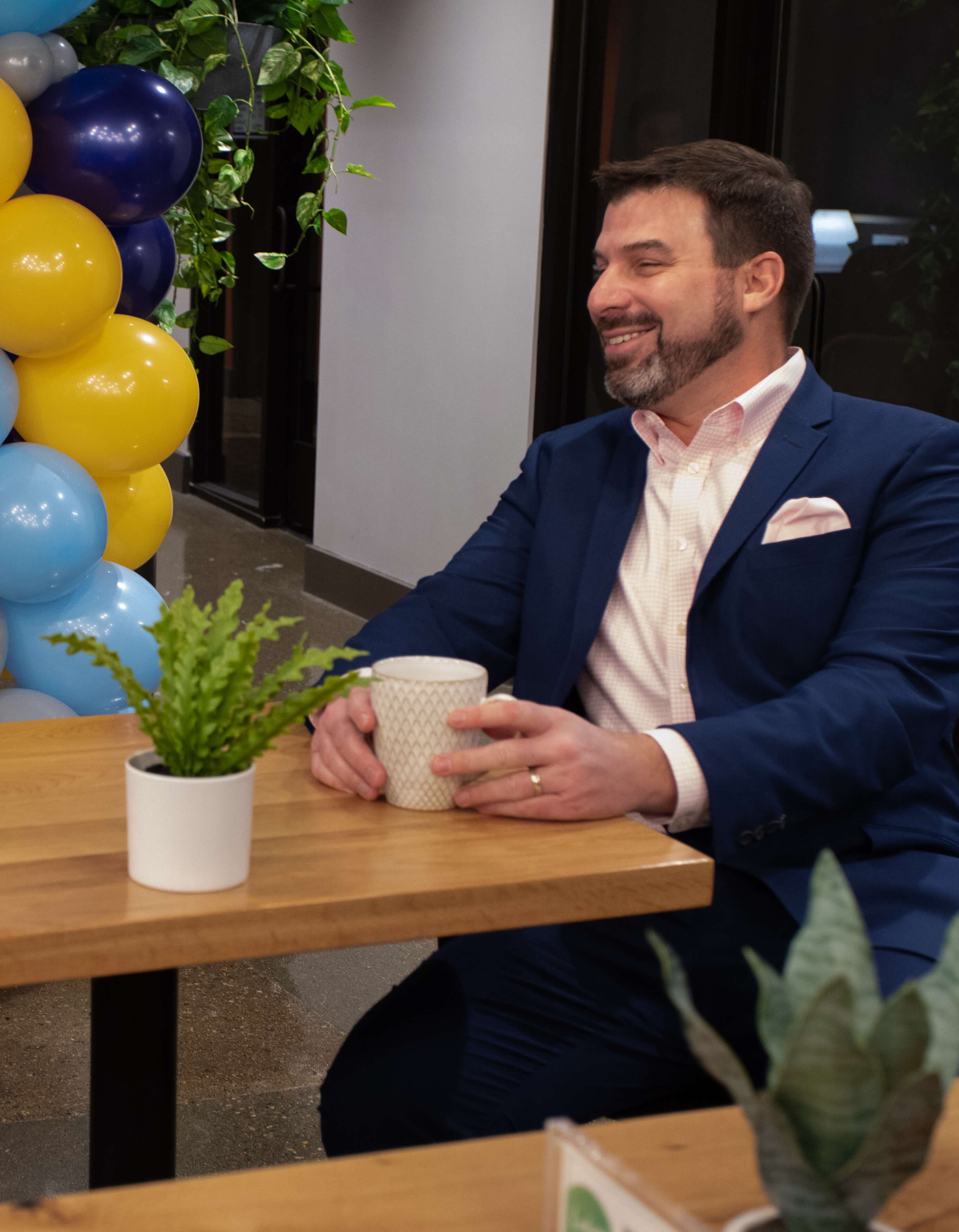 Eric Jaske drinking a cup of coffee at a table